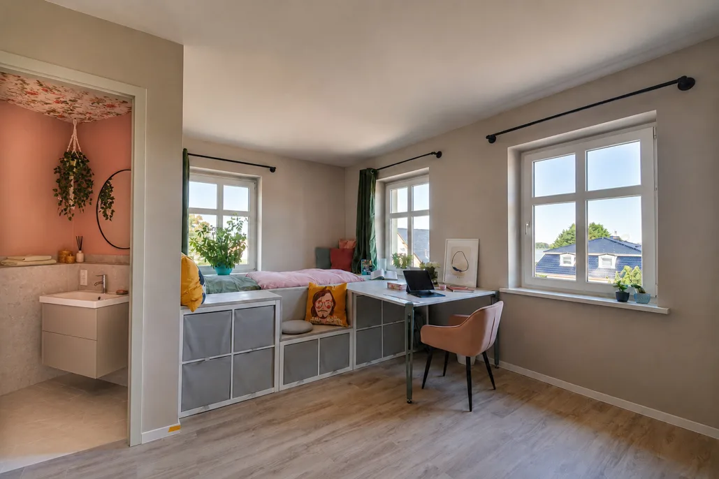 Heller Wohnraum einer möblierten Studentenwohnung in Neuruppin mit Bett, Schreibtisch und eigenem Bad